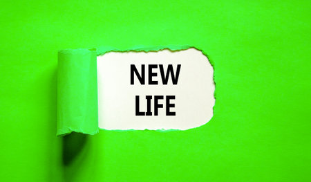 New life symbol. Concept words New life on beautiful white paper on a beautiful green background. Business, support, motivation, psychological and new life concept. copyspace.の写真素材