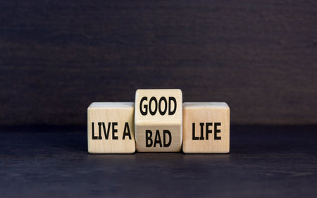 Live good life symbol. Concept word Live a good or bad life on wooden block on a beautiful gray table gray background. Business live a good or bad life concept. copyspace.の写真素材