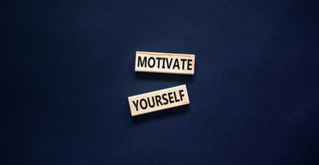 Motivate yourself symbol. Concept words Motivate yourself on beautiful wooden blocks. Beautiful black table black background. Business psychology motivate yourself concept. copyspace.の写真素材
