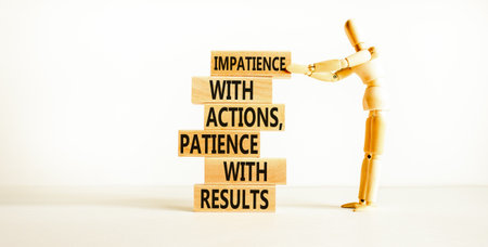 Action and result symbol. Concept words Impatience with actions patience with results on wooden block. Beautiful white table white background. Businessman icon. Business action result concept.の写真素材