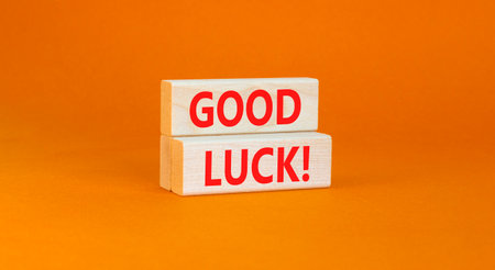 Good luck symbol. Concept words Good luck on beautiful wooden block. Beautiful orange table orange background. Business, motivational good luck concept. Copy space.の写真素材