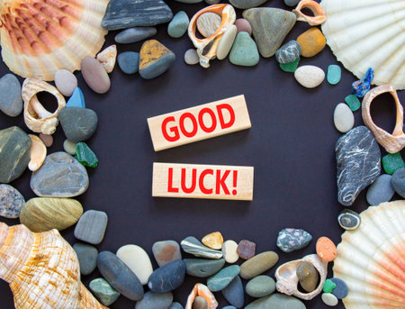Good luck symbol. Concept words Good luck on beautiful wooden block. Beautiful black table black background. Sea stone sea shell. Business, motivational good luck concept. Copy space.の写真素材