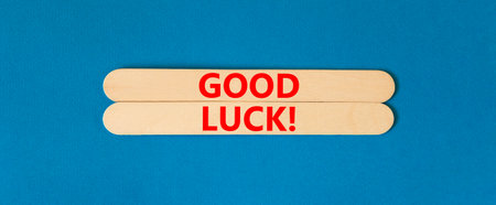 Good luck symbol. Concept words Good luck on wooden stick. Beautiful blue table blue background. Business, motivational good luck concept. Copy space.の写真素材