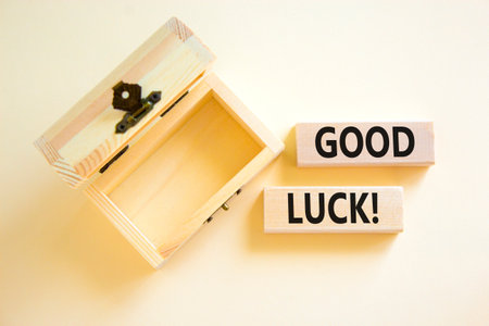 Good luck symbol. Concept words Good luck on beautiful wooden block. Beautiful white table white background. Empty wooden chest. Business, motivational good luck concept. Copy space.の写真素材