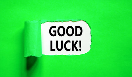 Good luck symbol. Concept words Good luck on beautiful white paper. Beautiful green table green background. Business, motivational good luck concept. Copy space.の写真素材