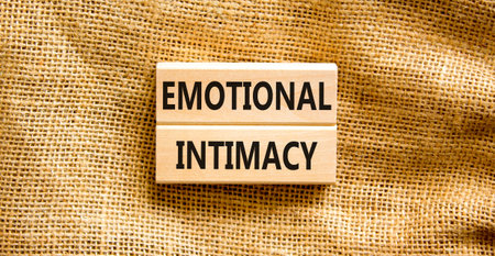 Emotional intimacy symbol. Concept words Emotional intimacy on beautiful wooden blocks. Beautiful...
