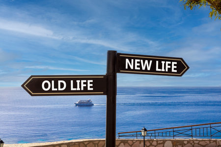 New or old life symbol. Concept word New life Old life on beautiful signpost with two arrows. Beautiful blue sea sky with clouds background. Business and new or old life concept. Copy space.の写真素材