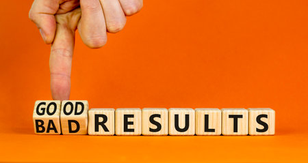 Good or bad results symbol. Concept words Good results Bad results on beautiful wooden blocks. Beautiful orange table orange background. Businessman hand. Business good bad results concept. Copy spaceの写真素材