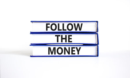 Follow the money symbol. Concept words Follow the money on beautiful books. Beautiful white table white background. Business and follow the money concept. Copy space.の写真素材