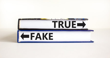 True or fake symbol. Concept word True or Fake on beautiful books. Beautiful white table white background. Business and true or fake concept. Copy space.の写真素材