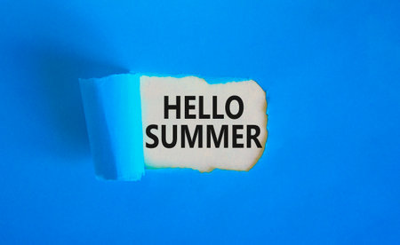Hello summer symbol. Concept words Hello summer on beautiful white paper. Beautiful blue paper background. Business lifestyle Hello summer concept. Copy space.の写真素材
