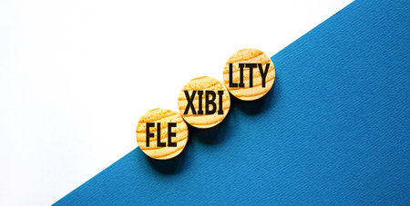 Flexibility symbol. Concept word Flexibility on beautiful wooden circles. Beautiful blue white...