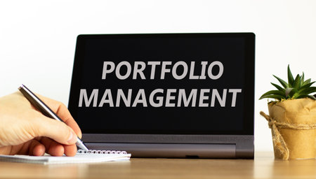 Portfolio management symbol. Concept words Portfolio management on beautiful black pad. Beautiful white background. Businessman hand. Business Portfolio management concept. Copy space.の写真素材