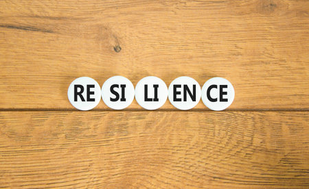 Resilience symbol. Concept word Resilience on beautiful white pill. Beautiful wooden background. Business resilience concept. Copy space.の写真素材
