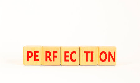 Perfection symbol. Concept word Perfection on beautiful wooden blocks. Beautiful white background. Business perfection concept. Copy space.の写真素材