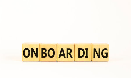 Onboarding success symbol. Concept word Onboarding on wooden blocks. Beautiful white background. Business onboarding success concept. Copy space.の写真素材