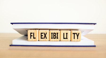 Flexibility symbol. Concept word Flexibility on beautiful wooden cubes in book. Beautiful wooden...