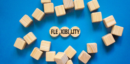 Flexibility symbol. Concept word Flexibility on beautiful wooden circles. Beautiful blue table blue...