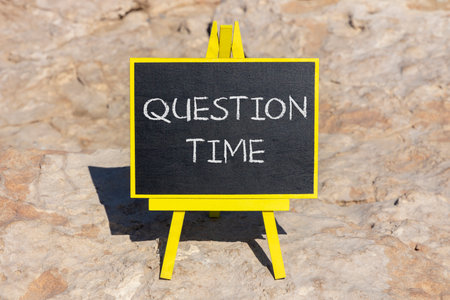 Question time symbol. Concept words Question time on beautiful yellow chalk blackboard. Beautiful stone beach background. Business and question time concept. Copy space.の写真素材