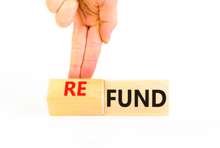 Fund or refund symbol. Concept words Fund Refund on wooden cubes. Beautiful gray table gray background. Businessman hand. Business and fund or refund concept. Copy space.の写真素材