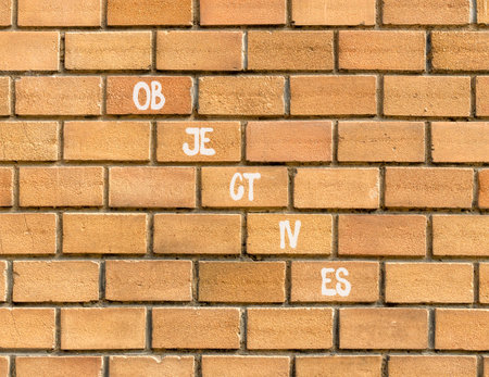 Objectives symbol. Concept word Objectives on beautiful brown bricks. Beautiful brown brick wall background. Business objectives concept. Copy space.の写真素材
