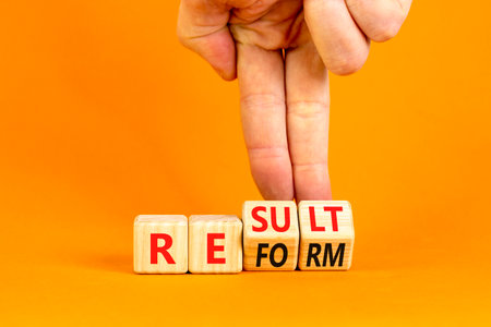 Reform and result symbol. Concept words Reform Result on beautiful wooden block. Beautiful orange table orange background. Businessman hand. Business Reform and result concept. Copy space.の写真素材