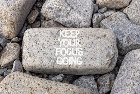 Keep your focus going symbol. Concept words Keep your focus going on beautiful gray stone. Beautiful gray stones background. Business and keep your focus going concept. Copy spaceの写真素材