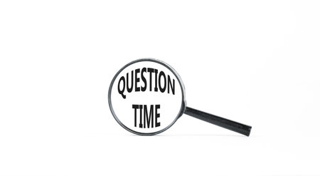 Question time symbol. Concept words Question time on beautiful white paper in magnifying glass. Beautiful white paper background. Business and question time concept. Copy space.の写真素材