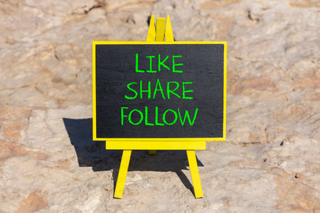 Like share follow symbol. Concept words Like Share Follow on beautiful black yellow blackboard. Beautiful stone background. Business like share follow concept. Copy space.の写真素材