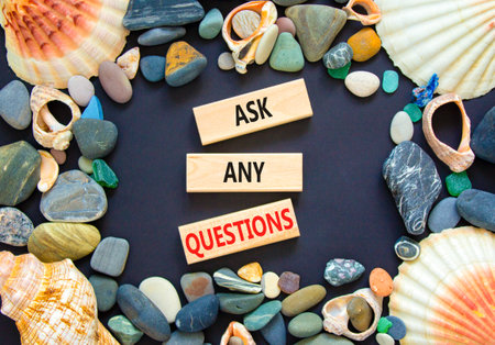 Ask any questions symbol. Concept words Ask any questions on beautiful wooden blocks. Beautiful black background. Sea shells and sea stones. Business ask any questions concept. Copy space.の写真素材