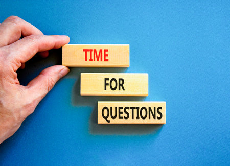 Time for questions symbol. Concept words Time for questions on beautiful wooden blocks. Beautiful blue background. Businessman hand. Business time for questions concept. Copy space.の写真素材