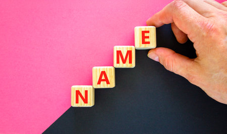 Name symbol. Concept word Name on beautiful wooden blocks. Businessman hand. Beautiful black and purple background. Business, lifestyle, support and name concept. Copy space.の写真素材