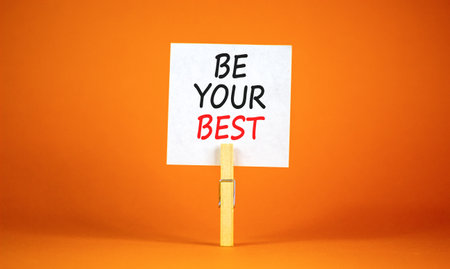 Motivational be your best symbol. Concept words Be your best on beautiful white paper on clothespin. Beautiful orange background. Business motivational be your best concept. Copy space.の写真素材