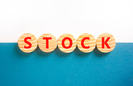 Stock symbol. Concept word Stock on beautiful wooden circles. Beautiful white and blue background. Business lifestyle stock concept. Copy space.の写真素材
