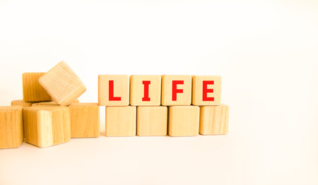 Life symbol. Concept word Life on beautiful wooden blocks. Beautiful white table white background. Business, lifestyle, support and life concept. Copy space.の写真素材
