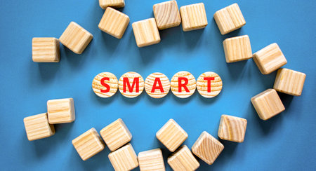 Smart symbol. Concept word Smart on beautiful wooden circles. Beautiful blue table blue background. Beautiful wooden cubes. Business lifestyle smart concept. Copy space.の写真素材