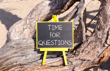 Time for questions symbol. Concept words Time for questions on beautiful black yellow blackboard. Beautiful old wood and sand background. Business time for questions concept. Copy space.の写真素材