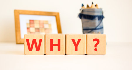 Why question symbol. Concept word Why question on beautiful wooden blocks. Beautiful white table white background. Business, lifestyle, support and why question concept. Copy space.の写真素材