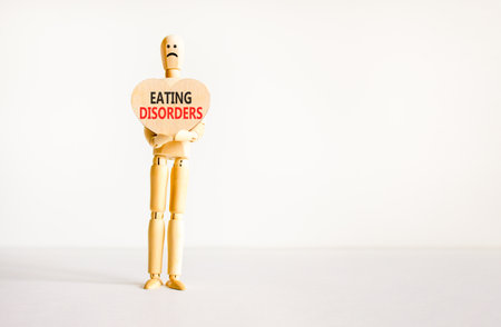 Eating disorders symbol. Concept words Eating disorders on beautiful wooden heart. Doctor's model....