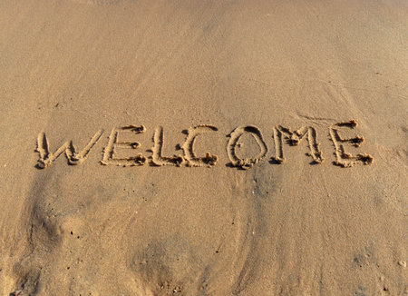 Business hello and welcome concept. Concept word Welcome written on beautiful Red sea ocean sand beach. Beautiful Red sea ocean sand beach background, copy space. Business hello and welcome concept.の写真素材