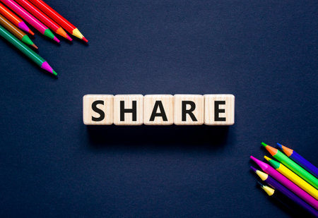 Share symbol. Concept word Share on beautiful wooden blocks. Beautiful black table black background. Beautiful colored pencils. Business lifestyle share concept. Copy space.の写真素材