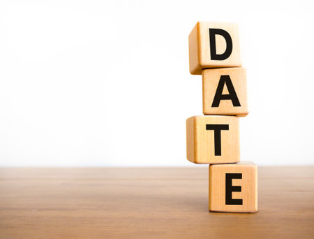 Date symbol. Concept word Date on beautiful wooden blocks. Beautiful wooden table white background. Business and date concept. Copy space.の写真素材