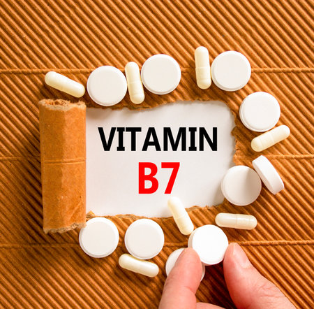 Vitamin B7 biotin symbol. Concept words Vitamin B7 on beautiful white paper. White pills tablets. Doctor's hand. Beautiful brown background. Medical healthy lifestyle Vitamin B7 biotin concept.の写真素材