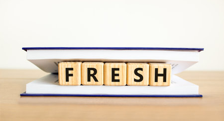 Fresh symbol. Concept word Fresh on beautiful wooden blocks in book. Beautiful wooden table white background. Copy space.の写真素材