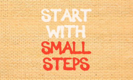 Start with small steps symbol. Concept words phrase Start with small steps on beautiful brown brick...
