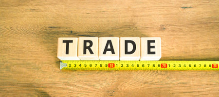Trade symbol. Concept word Trade on beautiful wooden blocks. Beautiful wooden table wooden background. Beautiful yellow ruler. Business lifestyle trade concept. Copy space.の写真素材