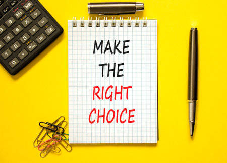 Make the right choice symbol. Concept words phrase Make the right choice on beautiful white note. Black pen. Calculator. Beautiful yellow background. Business Make the right choice concept. Copy spaceの写真素材