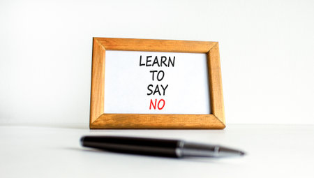 Learn to say no symbol. Concept words phrase Learn to say no on beautiful wooden picture frame. Black pen. Beautiful white background. Business psychological Learn to say no concept. Copy space.の写真素材