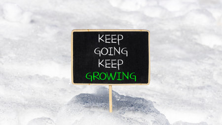 Keep going and growing symbol. Concept words phrase Keep going keep growing on beautiful black...