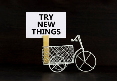 Try new things symbol. Concept words Try new things on beautiful white paper on wooden clothespin. Beautiful black background. Business motivational lifestyle try new things concept. Copy space.の写真素材